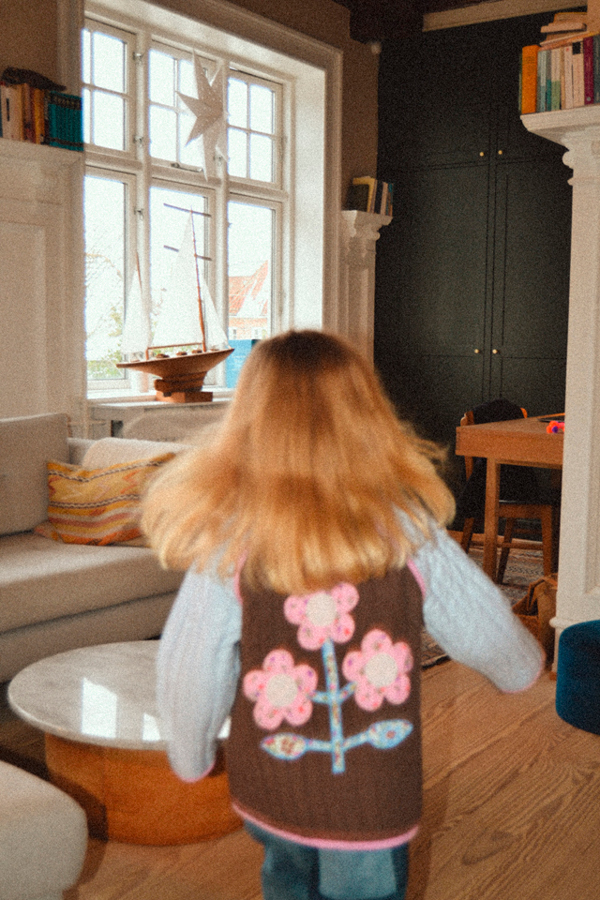 Pige løber væk fra kameraet i Sissel mini jakke